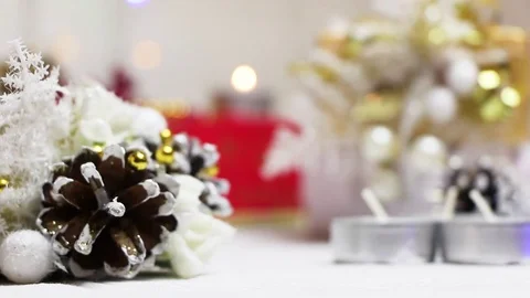 Lights candles in the New Year's setting with a bump and gift boxes Stock Footage 82407307