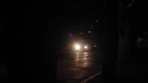 Lights of a car getting closer at night Stock Footage 324755722