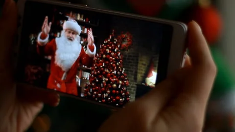 Lights on the Christmas tree. Blurred background. Woman looking Santa Claus Stock Footage 121994552