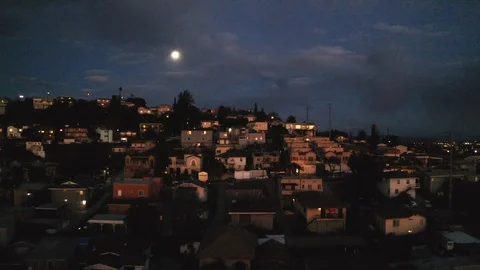 Lights come on in hillside homes as camera dollies by Video stock 103187490