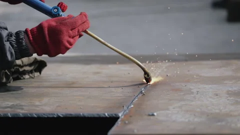 The lights coming out of the welding machine used by the worker inside the Stock Footage 151847704