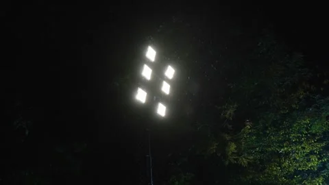 Lights from a construction site in a rainy night. 6 spot light Video stock 257832443