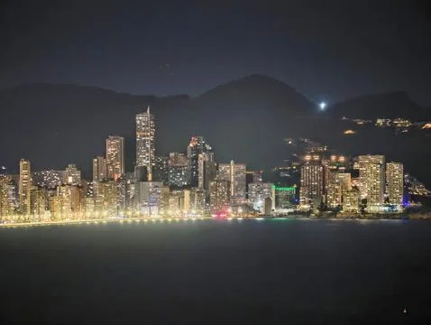 Lights Dance Over Tranquil Harbor, Cityscape At Night With Glowing Lights And Fotos Stock