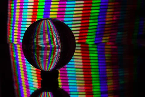 Lights of different colors reflected in a transparent glass ball. Light paint Stock Illustration