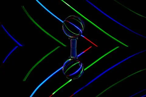 Lights of different colors reflected in a transparent glass ball. Light paint Stock Illustration