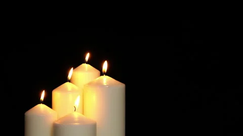 Lights five white candles on black background Stock Footage 236747585
