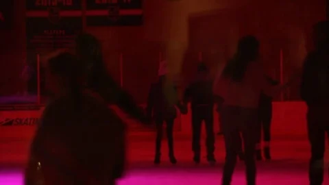 Lights flash and change on people ice skating Stock Footage 82490694