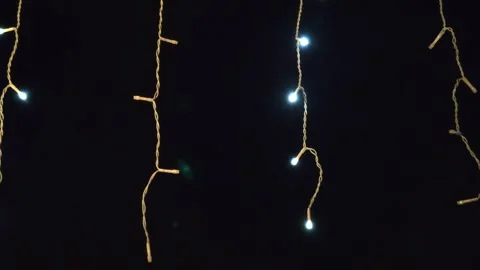 The lights flicker and glow in the darkness on the street Видео 323560372