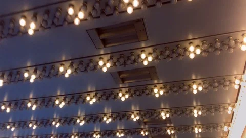 Lights Flicker in Sequence on Underside of Metallic Building Awning Stock Footage 100566068