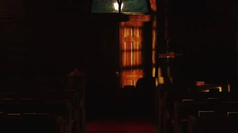 Lights go out in church pew. Church pew lit by window light goes dark Stock Footage 166364905