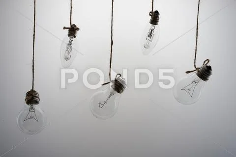 Lights hanging on a white background Stock Photos