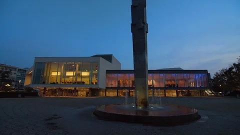 Lights inside a Beautiful Modern Building with Large Windows at Nighttime Видео 120554223