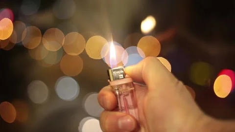 Lights a lighter with a man's hand Stock Footage 143400457