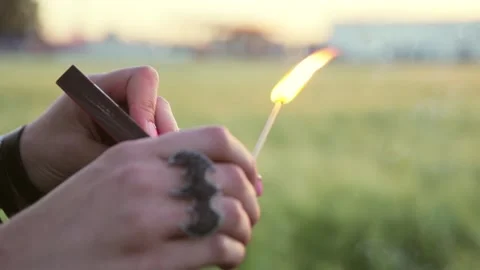 Lights a match on a matchbox Stock Footage 134460472