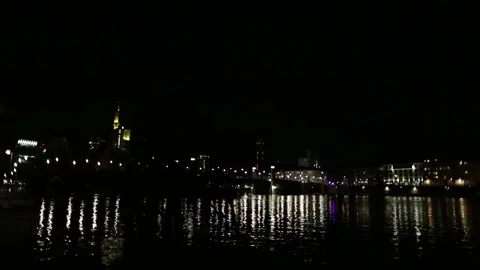 The lights of the night city are reflected in the black water Stock Footage 130371089
