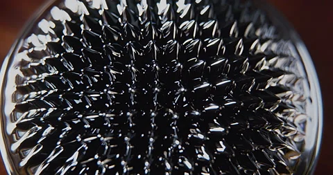 Lights over a black ferro fluid magnetic surface Stock Footage 152417415