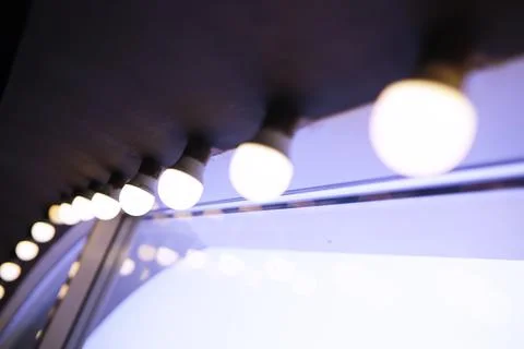 Lights in a row. Lamp hanging from the ceiling in the building. Arranged in.. Stock Photos