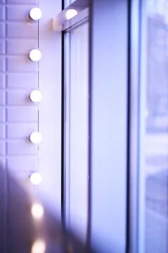Lights in a row. Lamp hanging from the ceiling in the building. Arranged in.. Stock Photos