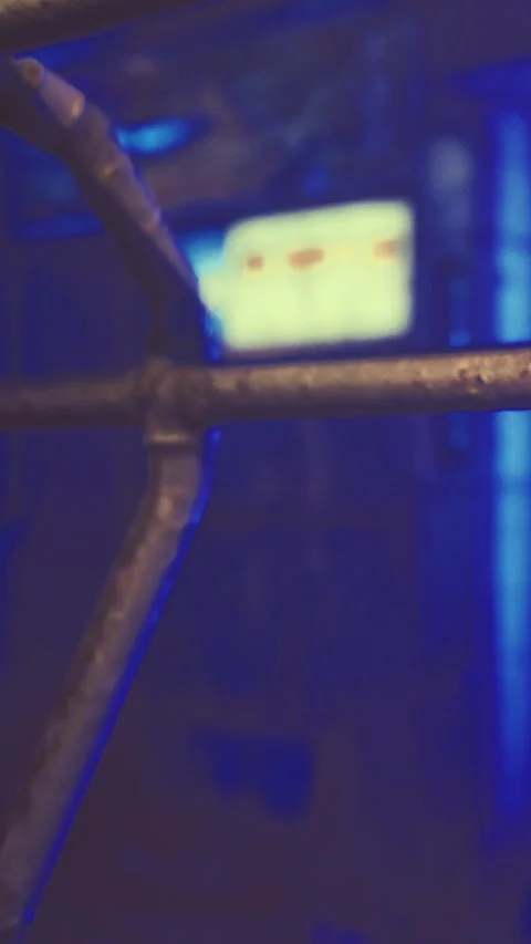 Lights shine through a metal structure at night in a busy city scene Stock Footage 332232446