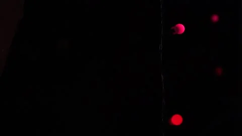 Lights shine by the window in the dark Stock Footage 145709059