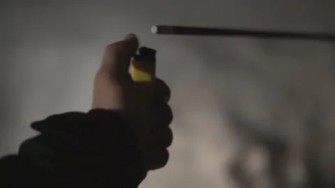 Lights a Sparkler with a lighter. Winter outside at night Stock Footage 102033508