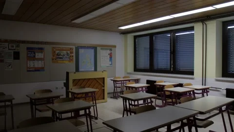 Lights turning on in dark classroom, wide static shot of empty class Stock Footage 167943833