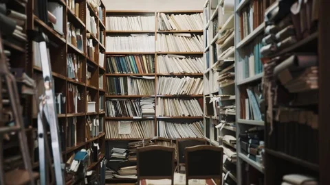 Lights turns on in old style library interior. Stepladder, books and folders Stock Footage 71927075