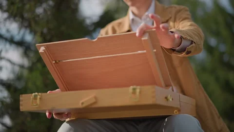 Lightweight art box with compartments and hinges. Convenient art easel case Stock-Footage 329790855