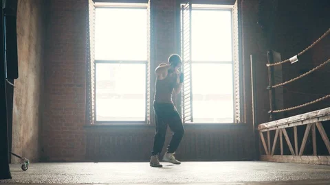 Lightweight boxer training in vintage stylized gym near the ring Stock Footage 87843457