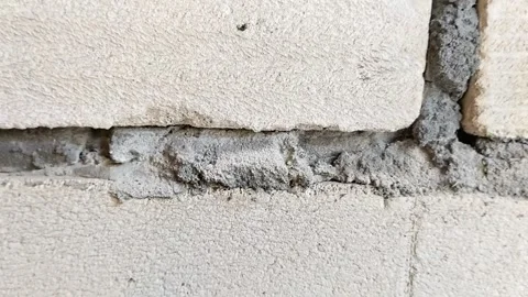 Lightweight concrete block wall with untidy mortar joints Stock Footage 314931572