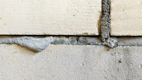 Lightweight concrete block wall with untidy mortar joints Stock Footage 314931608