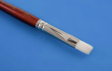 Lightweight precision makeup brush against a vibrant blue backdrop Stock Photos