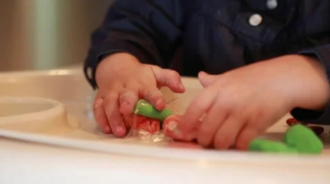 Liitle kid's hands, plasticine modeling, one year old girl Stock Footage 58074546