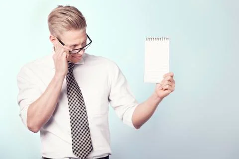 Likable businessman looking at empty notebook. Foto stock