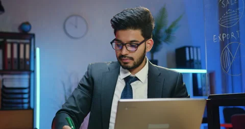 Likable concentrated experienced smart bearded businessman in suit working with Stock Footage 166675086