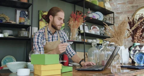 Likable concentrated modern bearded young worker from gift shop entering bank Stock Footage 143972267