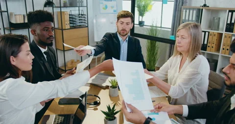 Likable confident hardworking mixed race different ages team working together Stock Footage 159585038