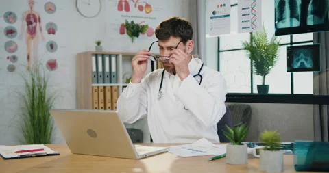 Likable confident purposeful qualified bearded doctor opening laptop,putting on Stock Footage 163221053