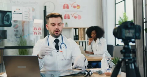 Likable confident successful skilled bearded doctor in medical gloves telling Stock Footage 159811422