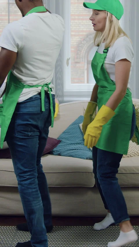 Likable hardworking young contented and fatigued mixed race workers of cleaning  Stock Footage 327872111
