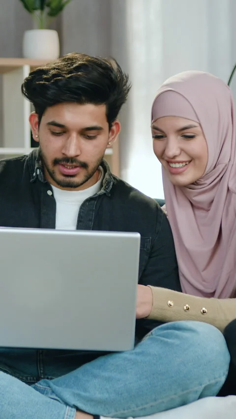 Likable joyful young loving bearded guy and his arabian girlfriend in hijab rela Stock Footage 328184688