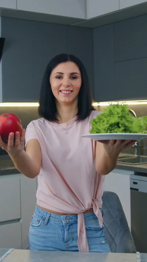 Likable smiling in high spirits 30-aged brunette standing in cozy cuisine and lo Stock Footage 330067277