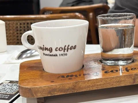 Likely coffee or tea, presented on a rustic, rectangular wooden tray. Stock Photos