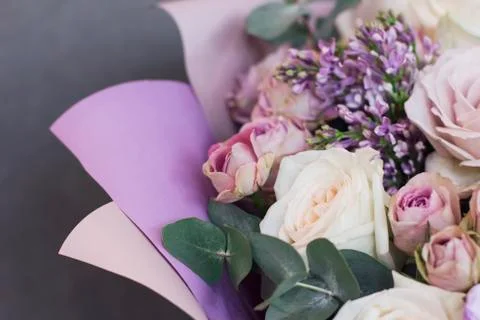 Lilac and eucalyptus in a large delicate bouquet on gray background Stock Photos