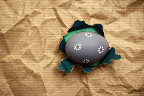 Lilac Eastern egg in hole brown wrapping paper Eastern egg in hole brown c... Stock Photos