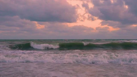 Lilac Gray Rain Clouds Orange Sky in Sunlight Ocean Foaming Waves Super Slow Mot Stock Footage 304665219