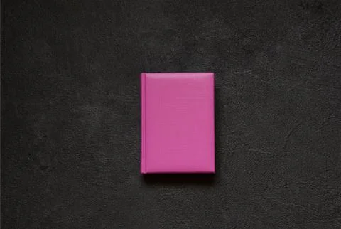Lilac notepad on black concrete background. Top view. Foto stock