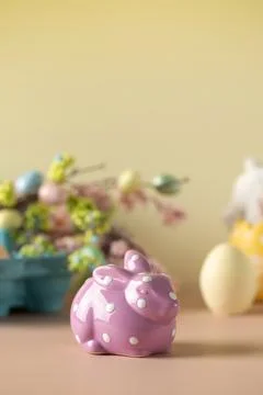 Lilac rabbit on a yellow Easter background. The concept of Easter. Stock Photos