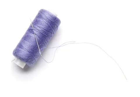 Lilac sewing thread with needle on white background Stock Photos