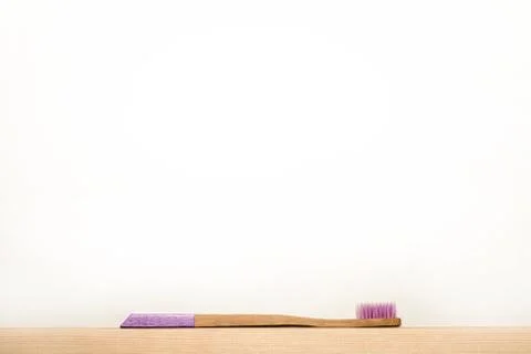 Liliac bamboo toothbrushes on white background. Stock Photos
